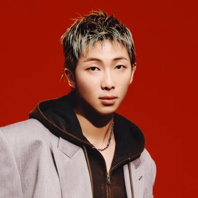 RM in rolling stone cover with a brown jacket and black hoodie.